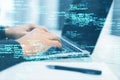 Close up of male hands using laptop keyboard on desk with pen and creative coding html language on blurry background. Web