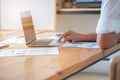 Close-up of male hands using laptop, man`s hands typing on laptop keyboard, side view of businessman using computer in meeting Royalty Free Stock Photo