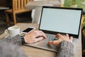 Close-up of male hands using modern laptop at home or cafe interior, young professional businessman working at his office via Royalty Free Stock Photo