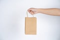 Close up male holding in hand brown clear empty blank craft paper bag Royalty Free Stock Photo
