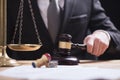 Close up of Male lawyer or judge hand`s striking the gavel on so Royalty Free Stock Photo