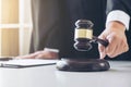 Close up of Male lawyer or judge hand`s striking the gavel on so