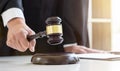 Close up of Male lawyer or judge hand`s striking the gavel on so