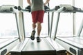 Close up of male legs running on treadmill in gym