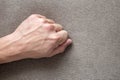 Close-up of male masculine hand with rough skin and short fingernails resting on flat copy space background, top view. Manual