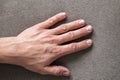 Close-up of male masculine hand with rough skin and short fingernails resting on flat copy space background, top view. Manual