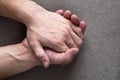 Close-up of male masculine young worker hands with rough skin and short fingernails resting on flat copy space background, top