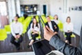 Close up of male mentor or coach hold paperwork, give flipchart presentation, talking with employees. Businessman have Royalty Free Stock Photo