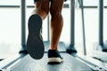 Close up male muscular feet in sneakers running on the treadmill at gym Royalty Free Stock Photo