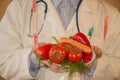 Close-up of male nutritionist hands measuring vegetables with tape. Man dietitian prescribing low-calorie food to patient