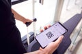 Close Up Of Male Passenger In Airport Looking At Digital Boarding Pass On Smart Phone