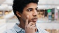 Close-up male pensive face, portrait african american puzzled business man standing indoors deep in thoughts thinking Royalty Free Stock Photo