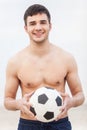 Close-up of male playing football on sand. Royalty Free Stock Photo