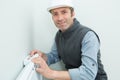 close-up male plumber fixing thermostat