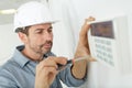 close-up male plumber fixing thermostat