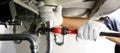 Close-up Of Male Plumber Fixing White Sink Pipe With Adjustable Wrench Royalty Free Stock Photo