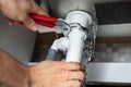 Plumber Fixing Sink Pipe With Adjustable Wrench Royalty Free Stock Photo