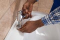 Plumber`s Hand Fixing Tap Of Sink Royalty Free Stock Photo