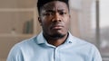 Close up male portrait of confused shocked african american millennial 30s man young adult guy worker feel displeasure Royalty Free Stock Photo