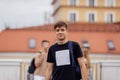 Close-up of a male portrait of a cute guy in a beige T-shirt with a black backpack