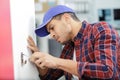 close-up male repairman fixing window with screwdriver Royalty Free Stock Photo