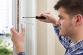 Repairman Fixing Window With Screwdriver Royalty Free Stock Photo