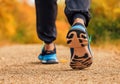 Close Up Of Male Runners Feet On Run Through Landscape