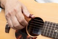 Close up of male`s fingers  placed on soundhole of the acoustic guitar for practicing in playing guitar Royalty Free Stock Photo