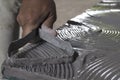 Close up of male sculptor holding tool and making art on clay. Clay master moulding. Clay modelling.