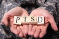 Male Soldier Holding Wooden Cubes With PTSD Text Royalty Free Stock Photo