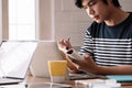 Close up of male student busy studying using laptop make notes in notebook while write watching webinar or online