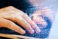 Close up of male student hand using laptop keyboard with abstract html code on creative city background. Coding and programming
