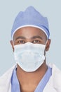 Close-up of a male surgeon wearing mask over light blue background Royalty Free Stock Photo