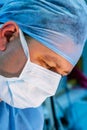 Close-up of male surgeon wearing surgical mask and cap