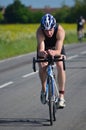 Close up of Male triathlete on road cycling stage.