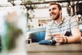 Close up of male using credit card contactless technology and smartphone for paying in restaurant