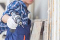 Close-up of Male in work gloves holding an electric screwdriver, Repair and maintenance concepts Royalty Free Stock Photo