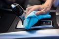 close-up male worker cleaning seat inside car Royalty Free Stock Photo