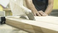 Close-up of male worker`s hands working with the circular saw and cutting large boards of wood in a workshop or plant Royalty Free Stock Photo