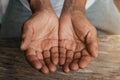 Close up of male wrinkled hands, old man is wearing on the wood table Royalty Free Stock Photo