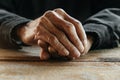 Close up of male wrinkled hands, old man is wearing on the wood table Royalty Free Stock Photo