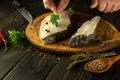 Close-up of a man adding aromatic parsley to Anarhichas fish before frying. Concept of delicious fish diet at home Royalty Free Stock Photo