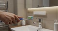 Morning Routine with Man Applying Toothpaste to Toothbrush Royalty Free Stock Photo