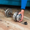 Close up of a man assembling a dumbbell