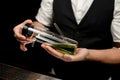 Close-up. Man bartender holds special designer glass flask with canabis cocktail inside