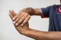 Close-up of a man bending his hand due to nerve endings