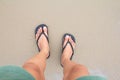 Close up of man in Black slippers feet standing at the beach, Royalty Free Stock Photo