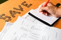 Close up of man with calculator counting making notes at home, c