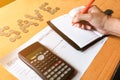 Close up of man with calculator counting making notes at home, c