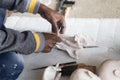 Close up of man ceramist hands holding a tool and working on sculpture details